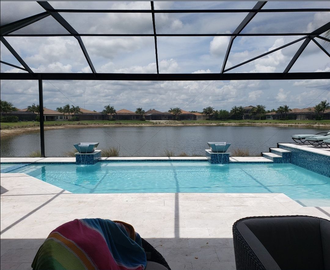 A large swimming pool with a hose attached to the side of it.