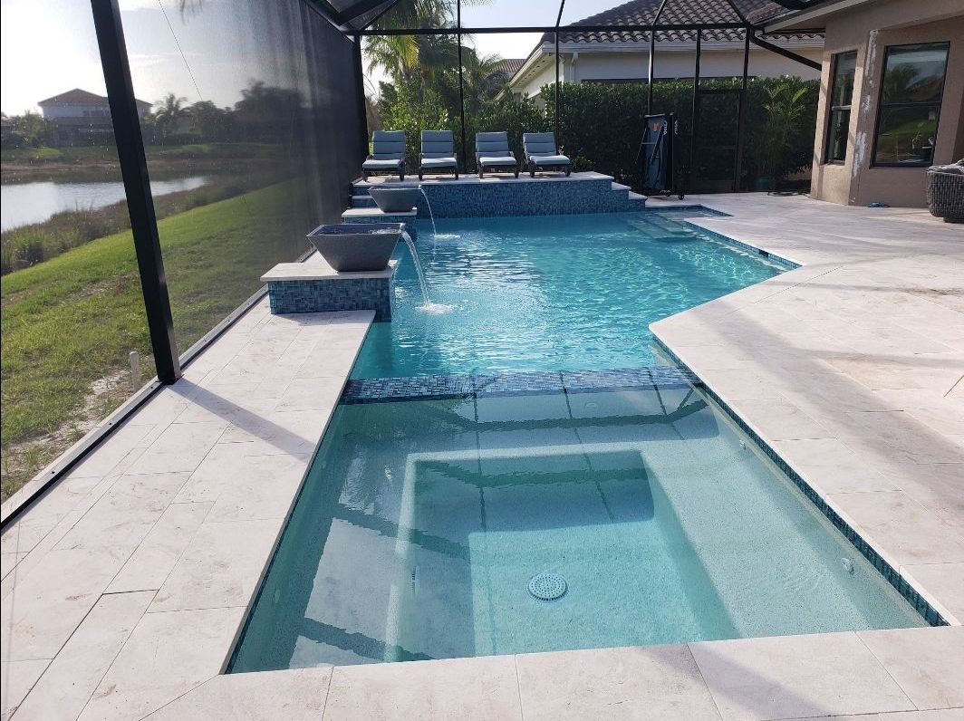 A large swimming pool with a house in the background.