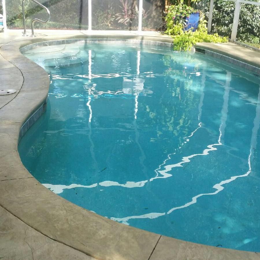 A large swimming pool with a fence around it.