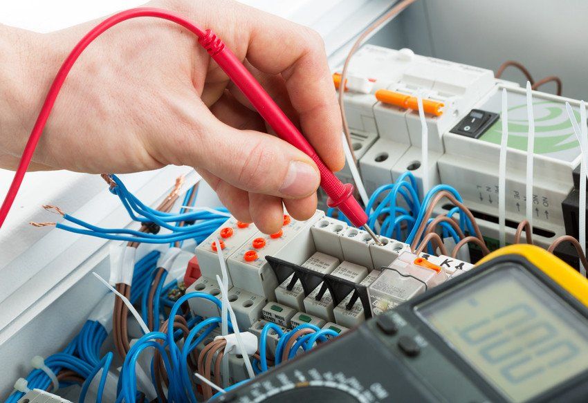 A service technician is using a modern multimeter to test the Voltage