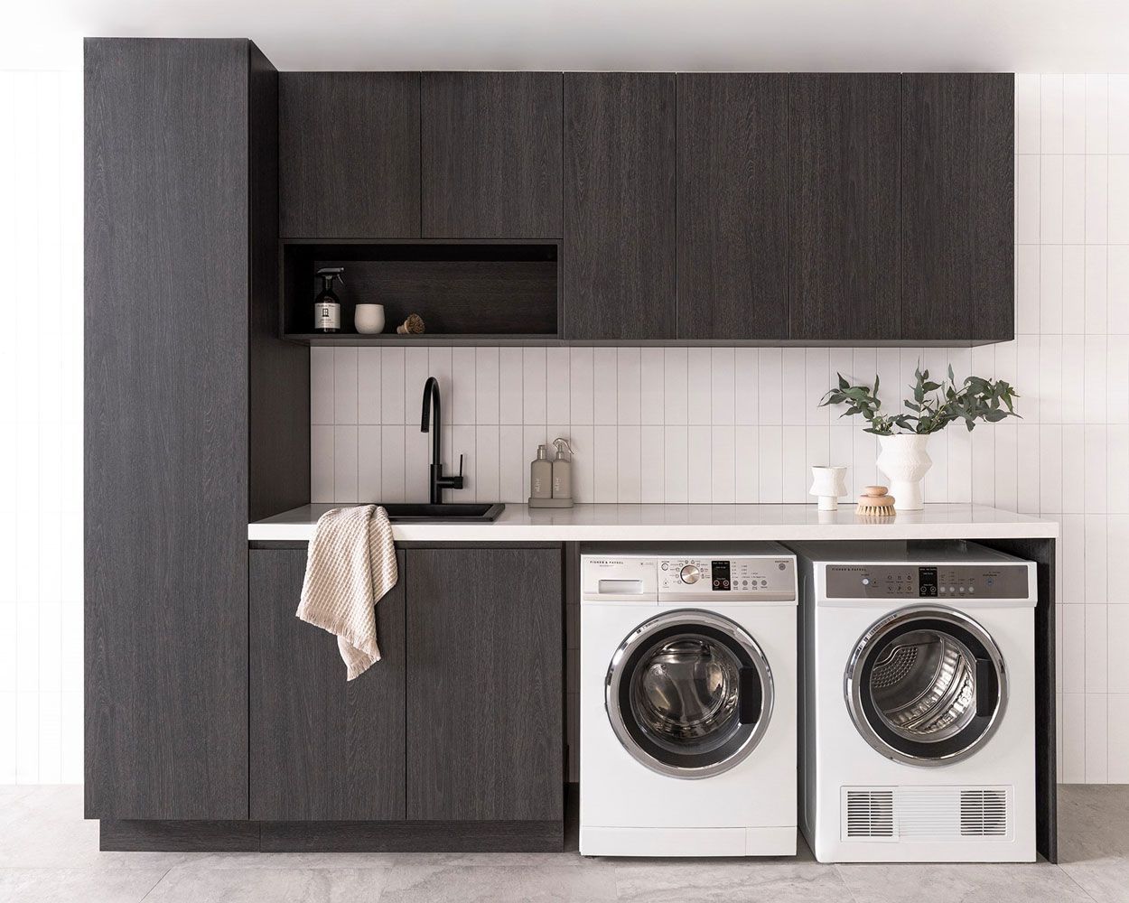 Laundry Area With Black Cabinets And Two Laundry Machines — Fixtures & Fittings In Tweed Heads South, NSW