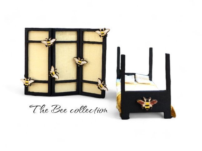 Miniature black bed and folding screen, both with yellow bee decorations.