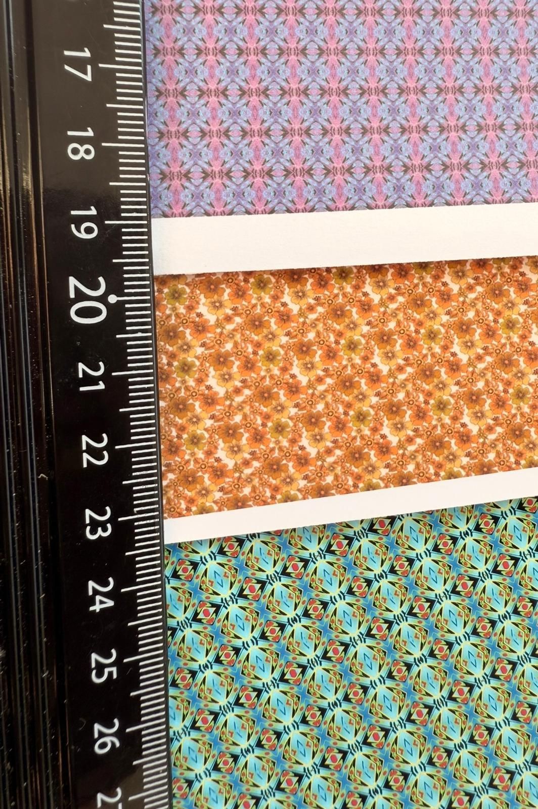 Three patterned paper strips with a ruler along the left side.