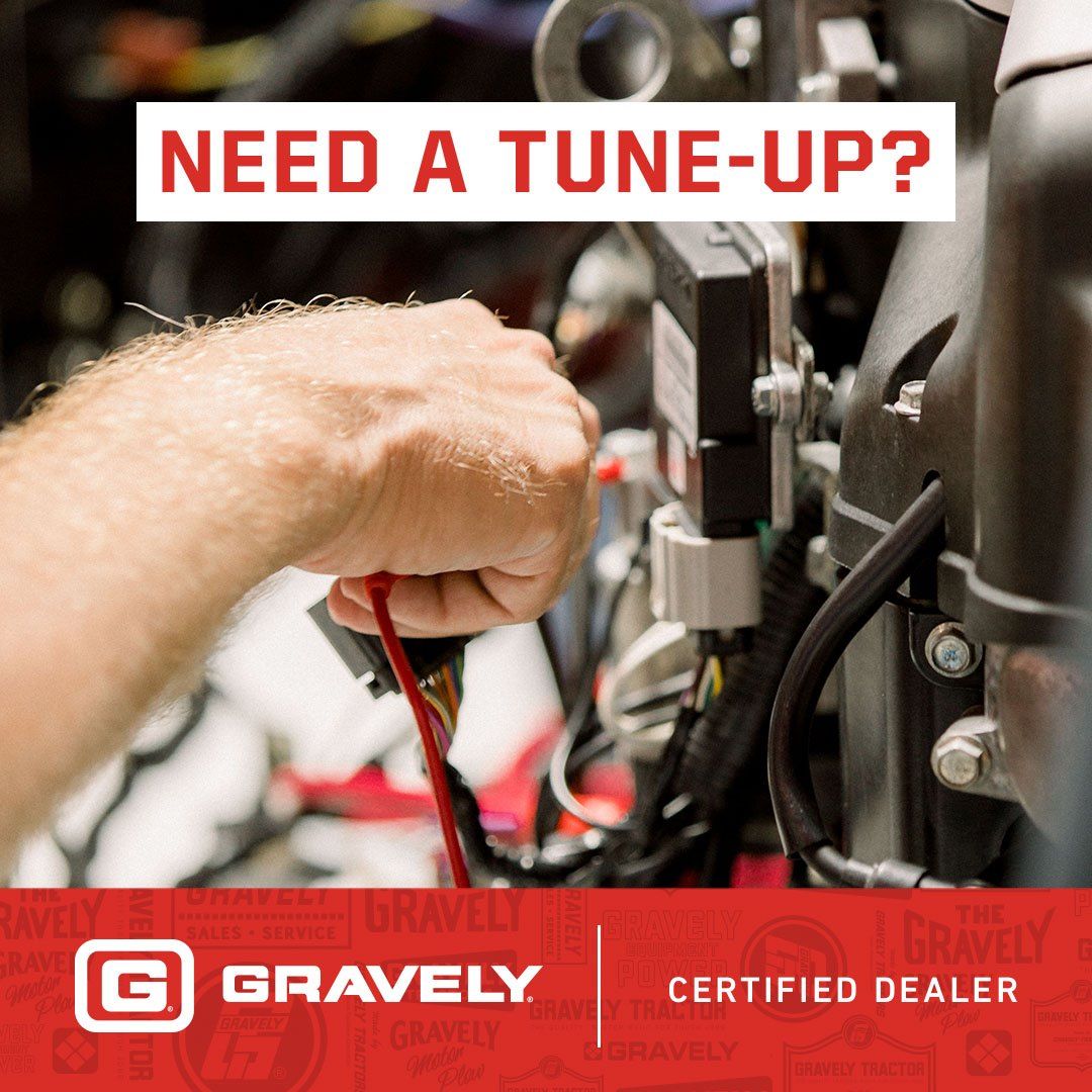 Hand reaching to wires on an engine, the words