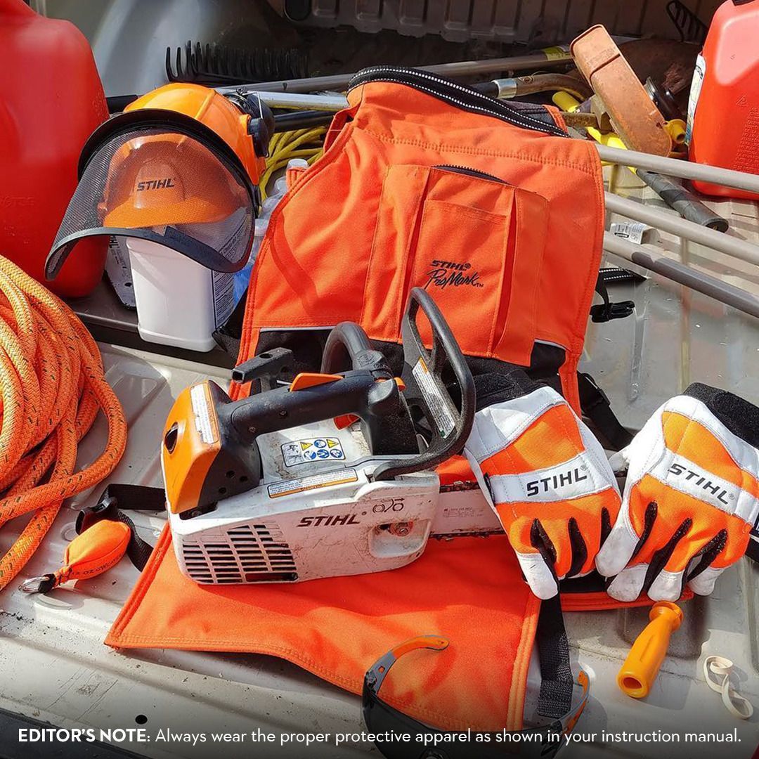 Orange chainsaw safety equipment including a helmet, gloves, and a chainsaw on a flat surface.