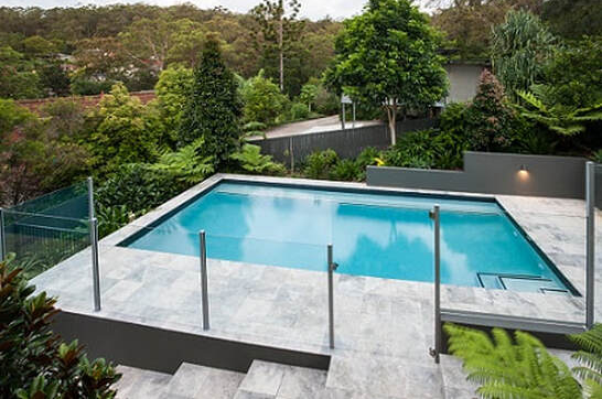 South West view of the glass pool fences, newly installed for a home backyard swimming pool in Ballarat, Victoria.