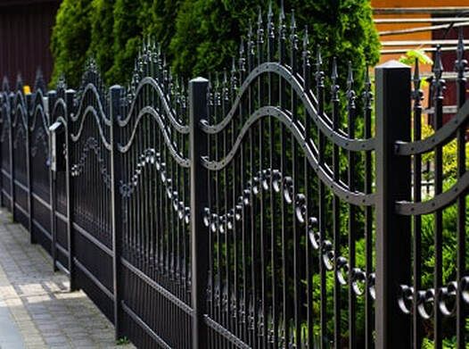 Black, freshly painted wrought iron fence installed as boundary fences for residential home in Light grey colorbond fence installed in a residential home in Ballarat, Victoria.