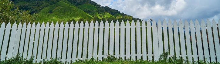 White wooden fence in Ballarat installed in rural area with mountain view.