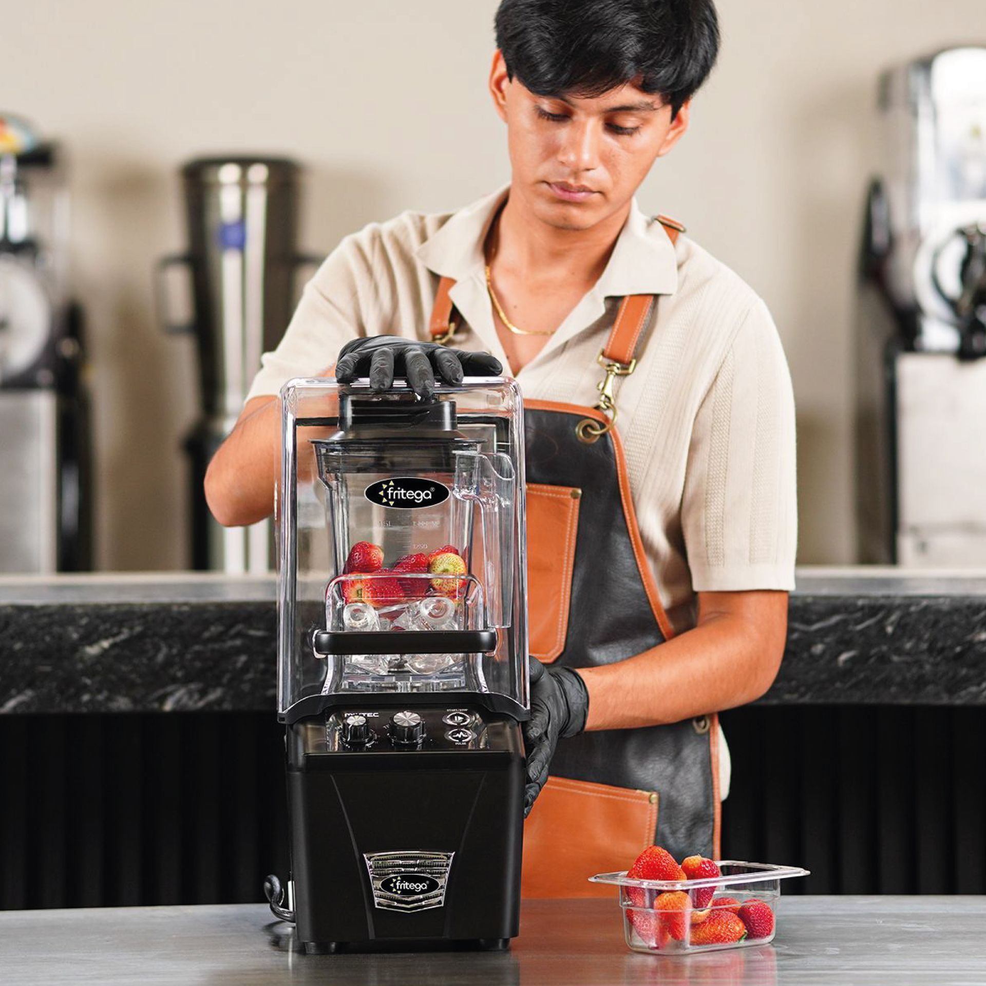 A person is using a blender to make a smoothie