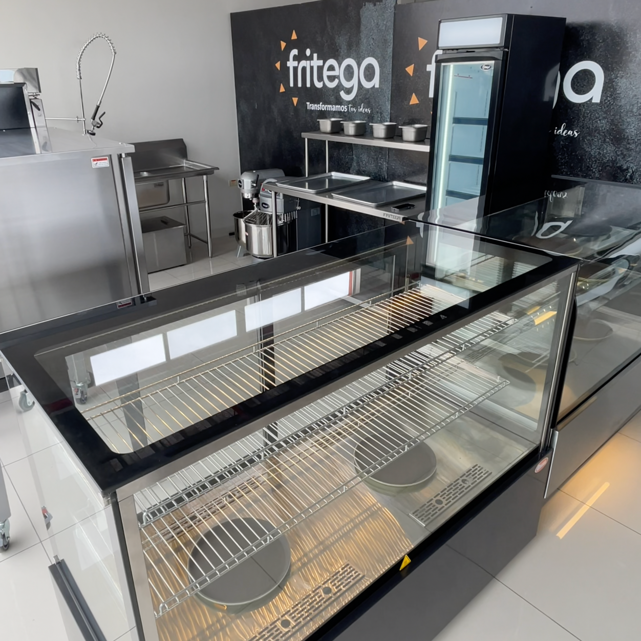 A person is mixing something in a mixer in a kitchen