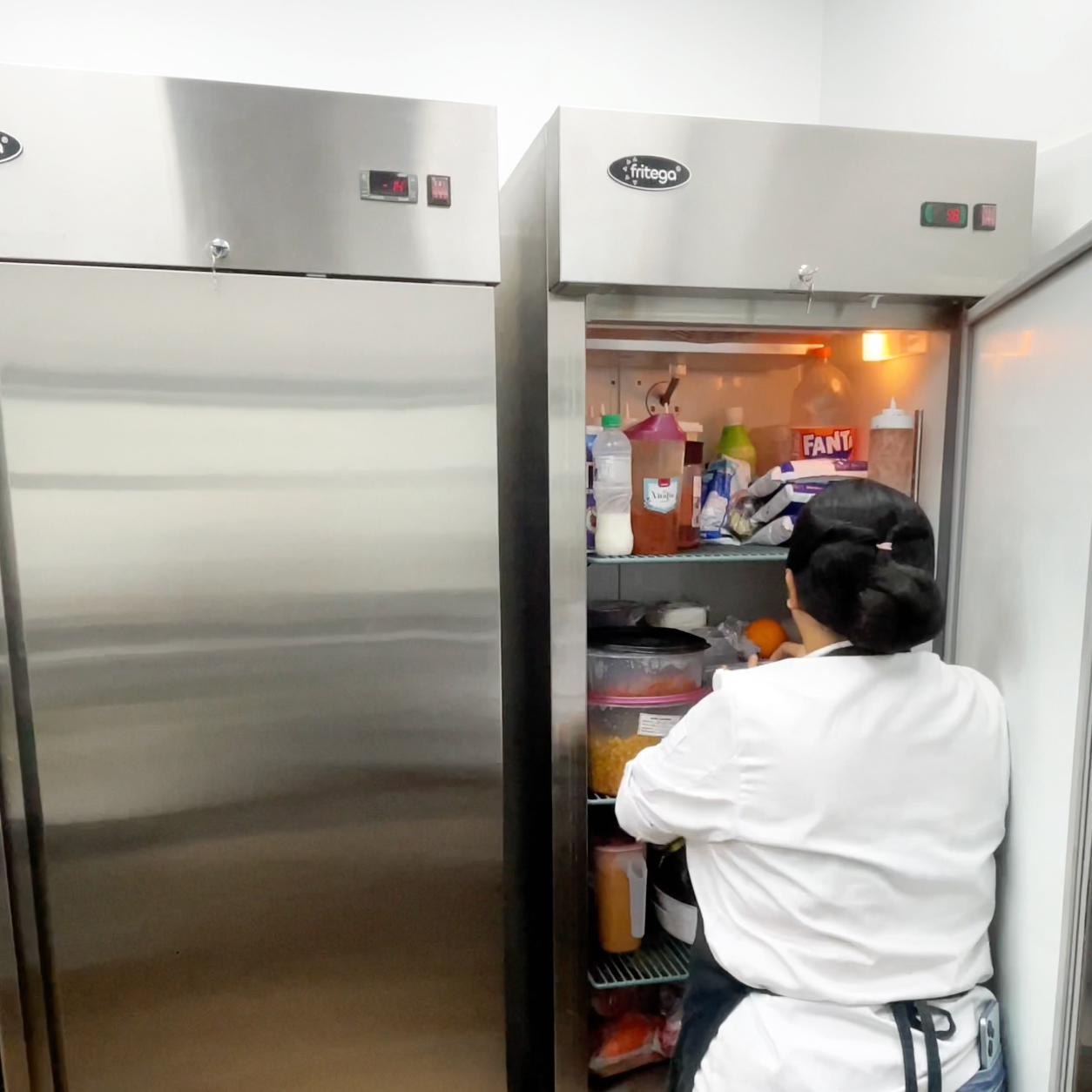 A kitchen with a stainless steel refrigerator , sink , and drawers.