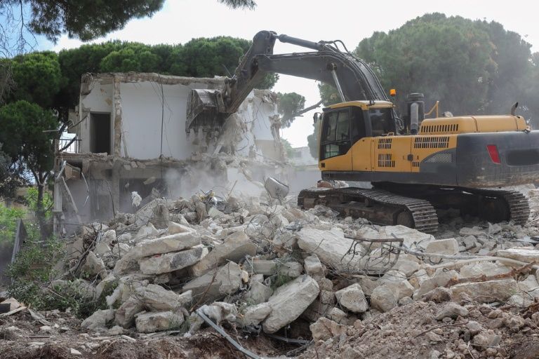A Large Yellow Excavator is Demolishing a Building — Al's Excavation in Sunshine Coast, QLD