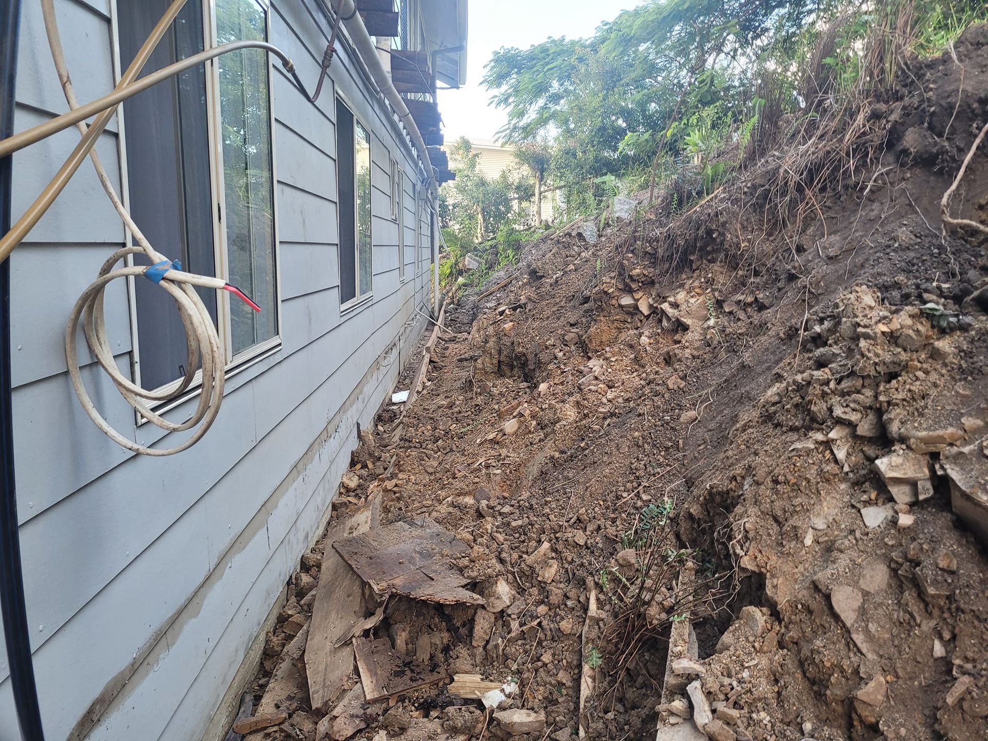 A large pile of dirt is sitting in front of a house. — Al's Excavation in Sunshine Coast, QLD