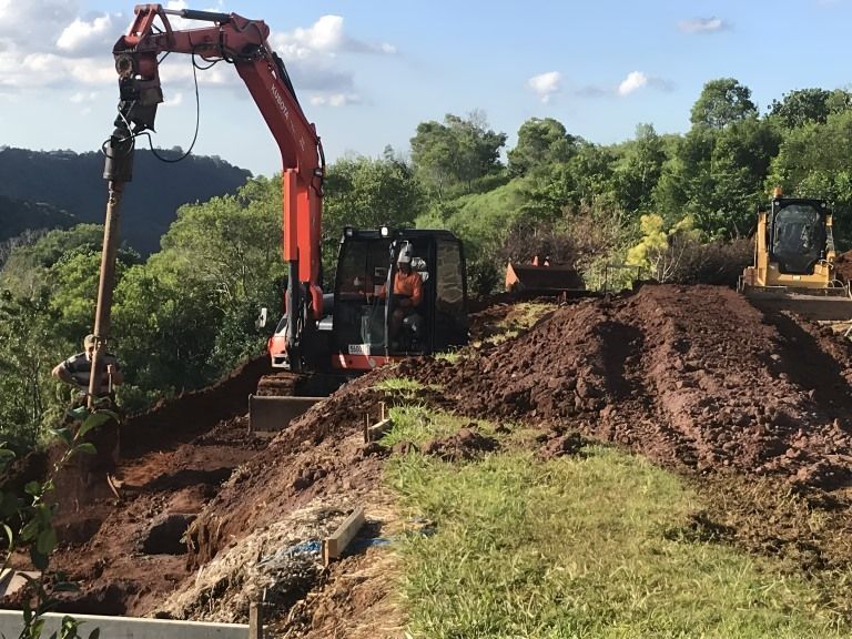 A Bulldozer is Digging a Hole in the Ground — Al's Excavation in Bridges, QLD