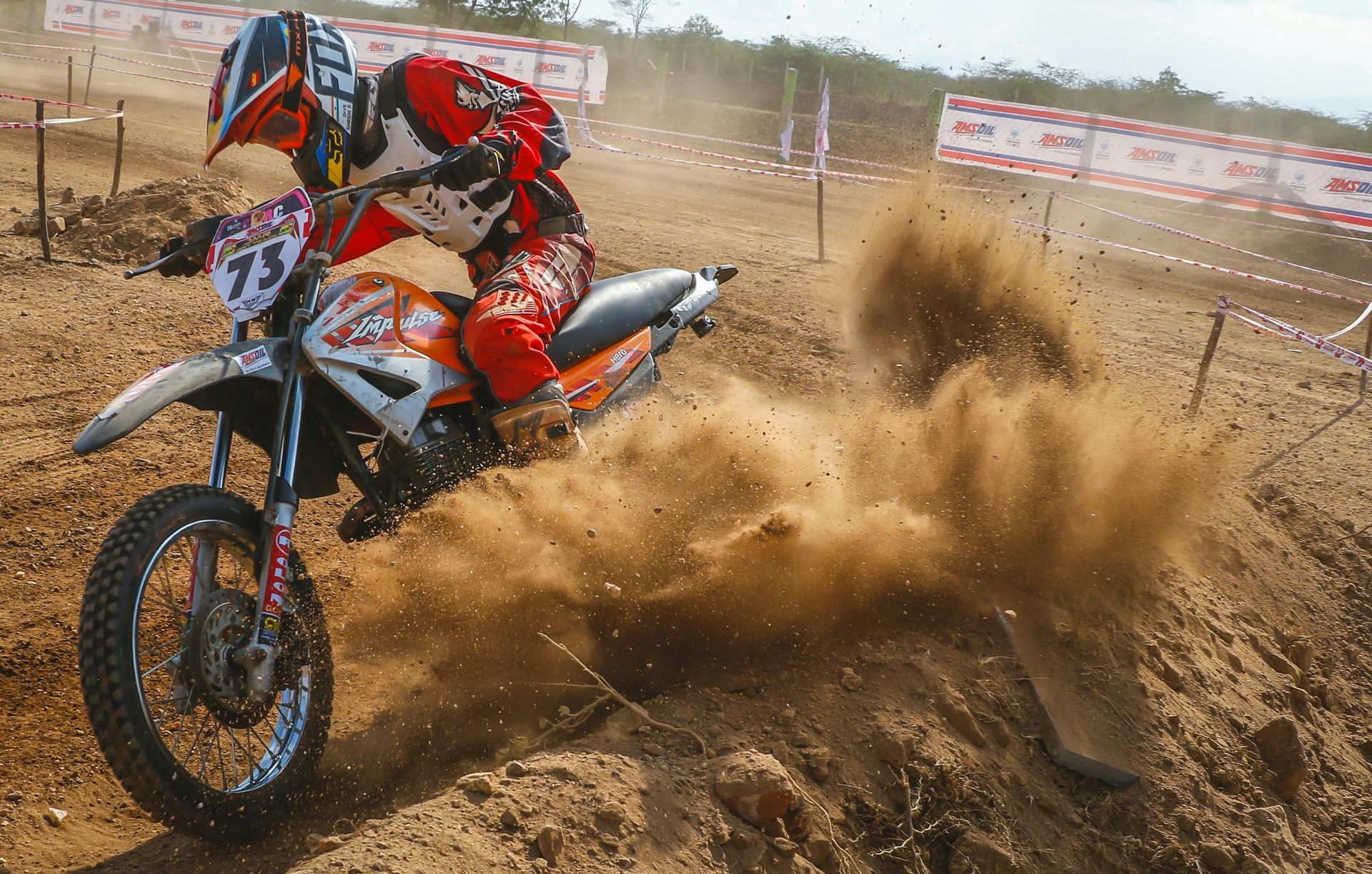 A person on a dirt bike with the number 75 on it