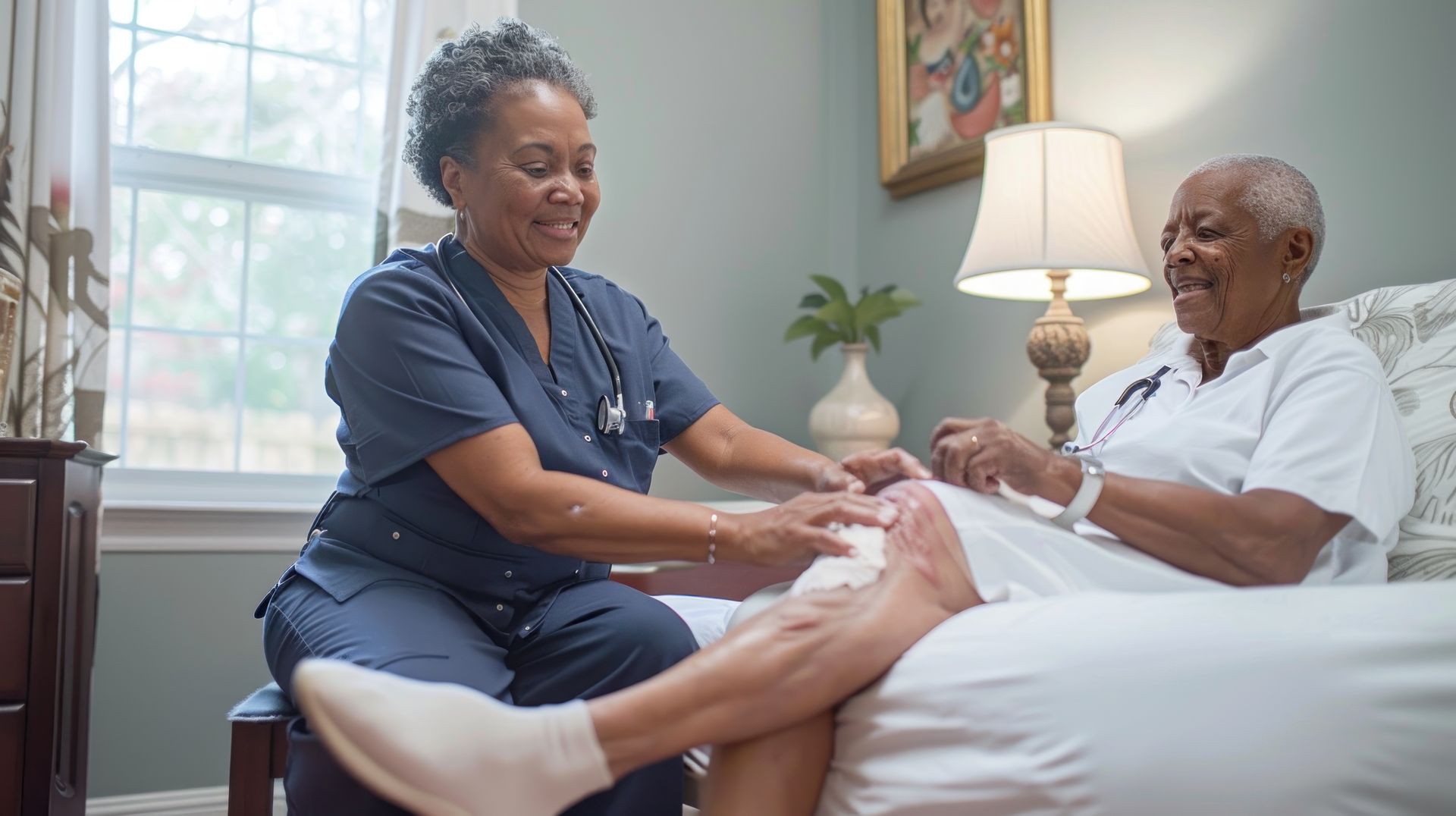 A dedicated home healthcare worker providing wound care for a senior woman. A dedicated home healthcare worker providing wound care for a senior woman.