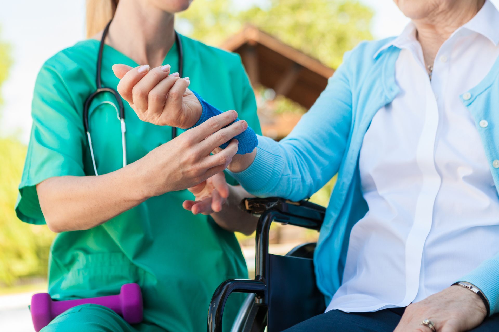 Nurse helping an injured senior woman in a wheelchair.