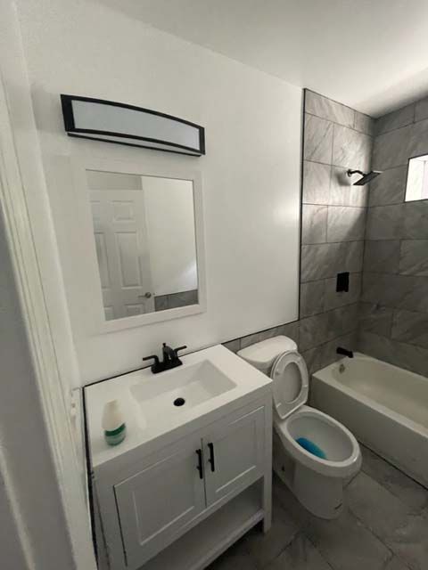 A bathroom with a sink , toilet and bathtub