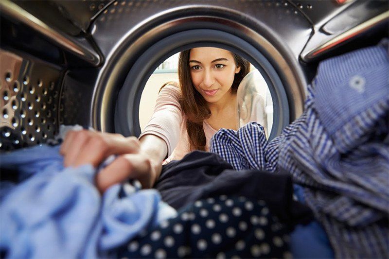 Woman Doing Laundry — Sarasota, FL — Southern Sanitary Systems Inc