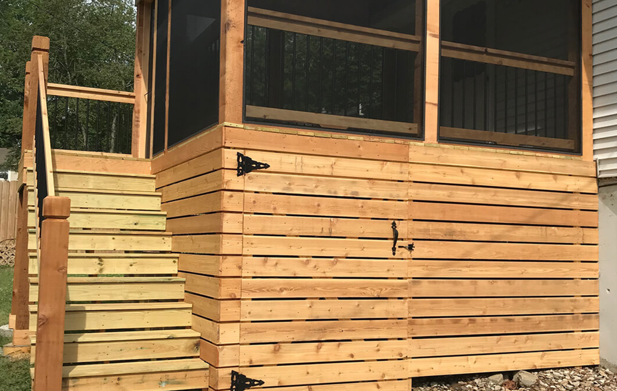 A man is measuring a piece of wood with a pencil.