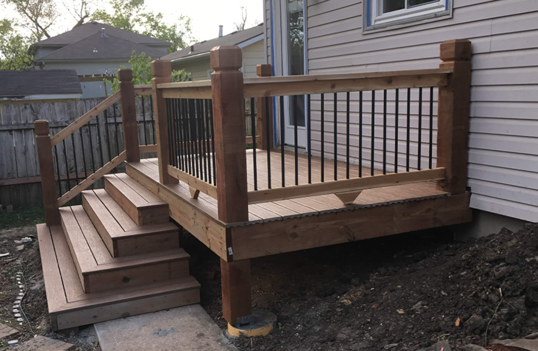 A tape measure , pencil , and square are on a wooden deck.