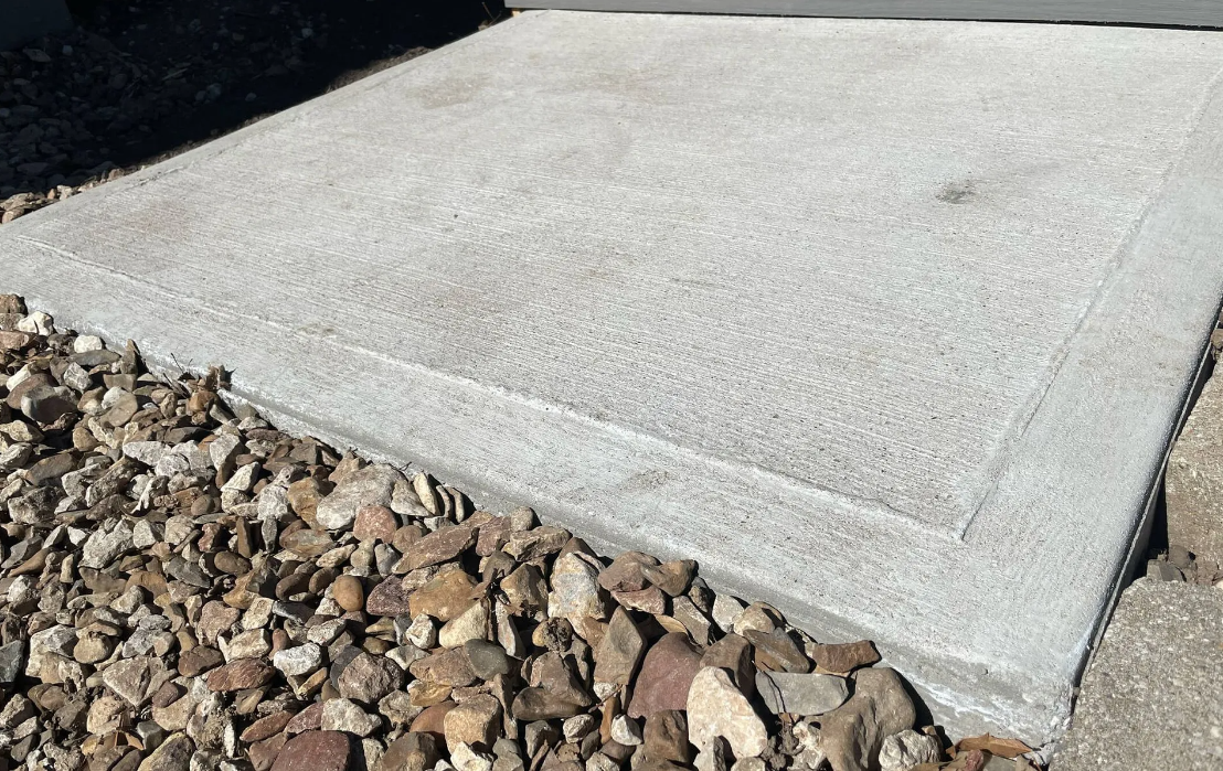 A concrete slab is sitting on top of a pile of gravel.