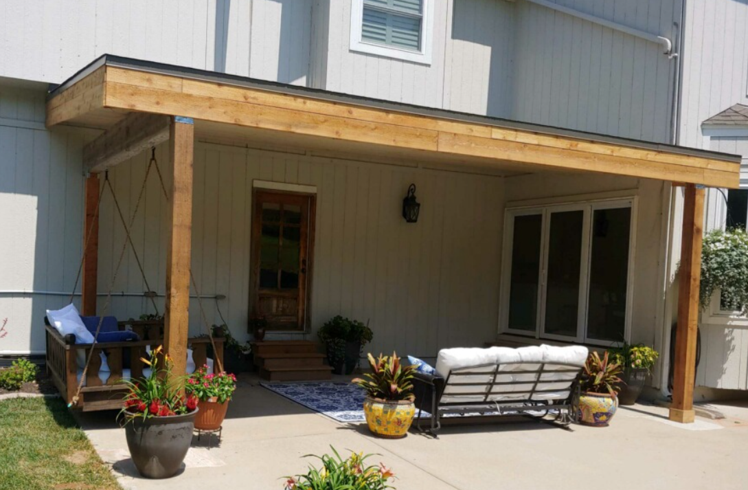 A wooden deck with benches in a park next to a lake.