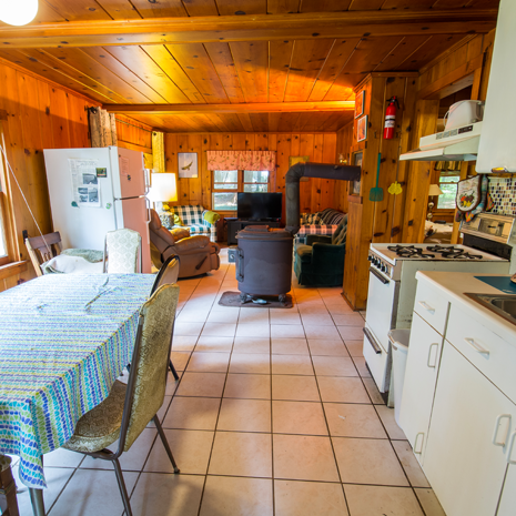 A kitchen with a table and chairs and a stove