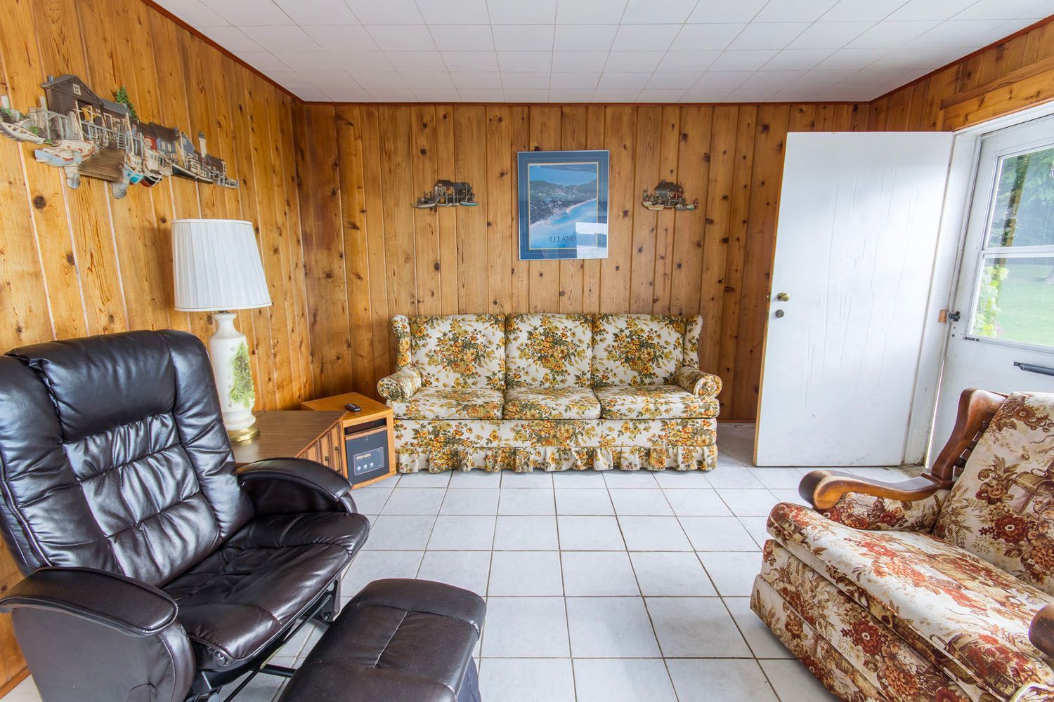 A living room with a couch , chair and ottoman