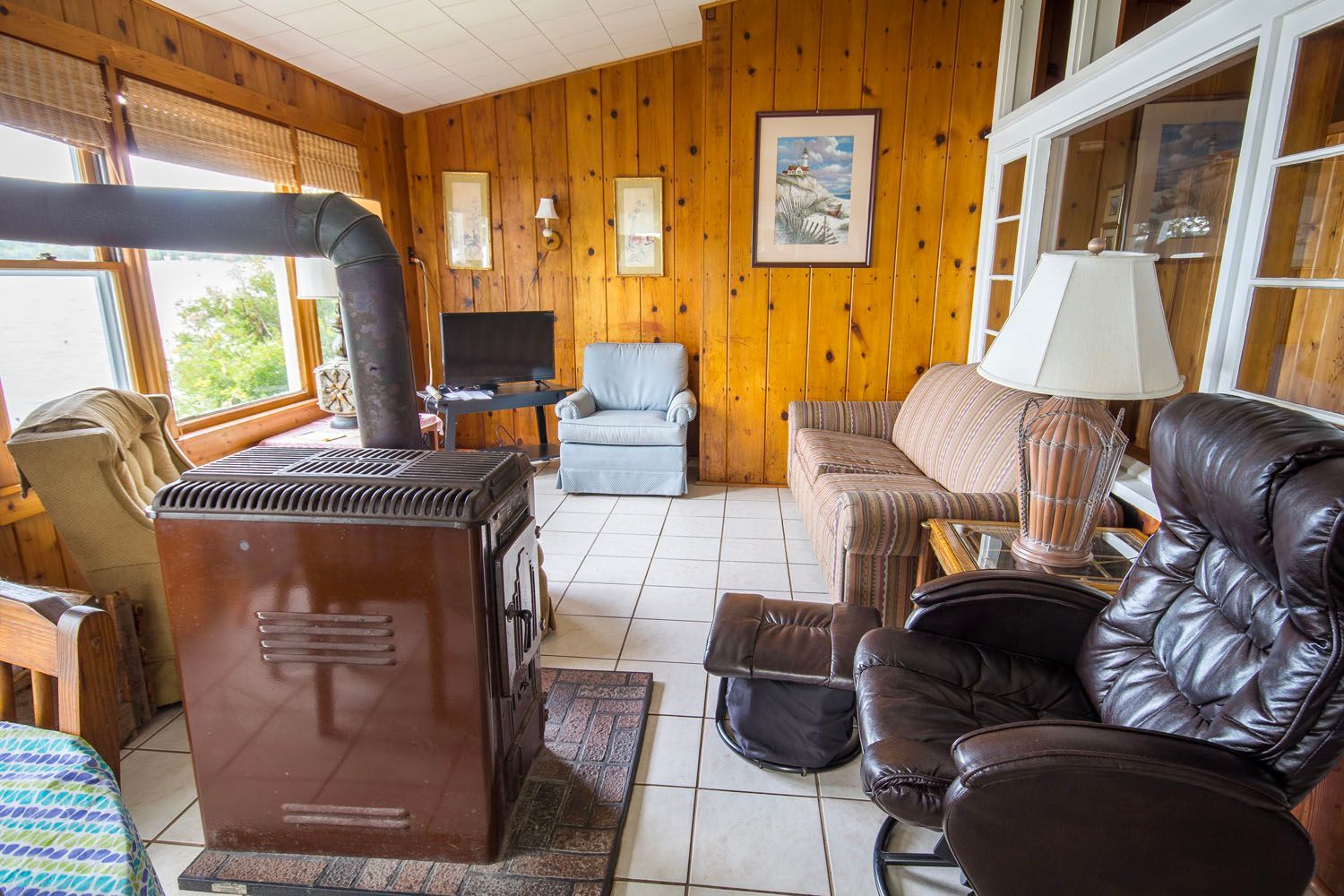 There is a wood stove in the middle of the living room.