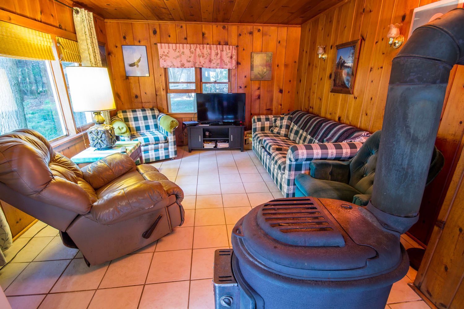 There is a wood stove in the middle of the living room