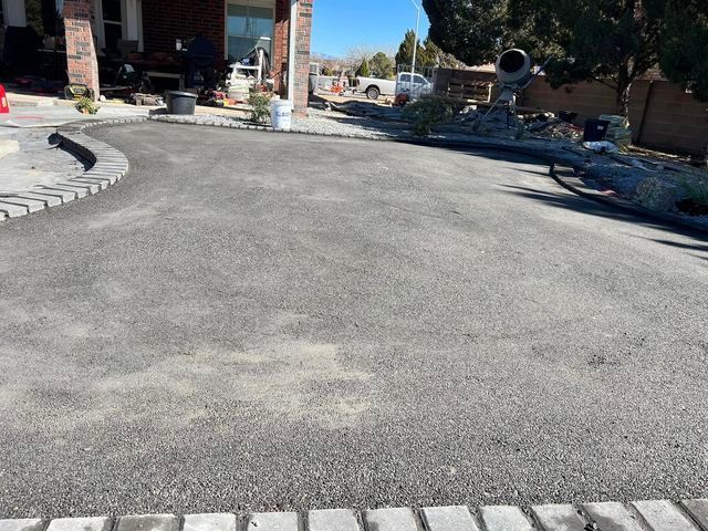 A driveway is being built in front of a house.