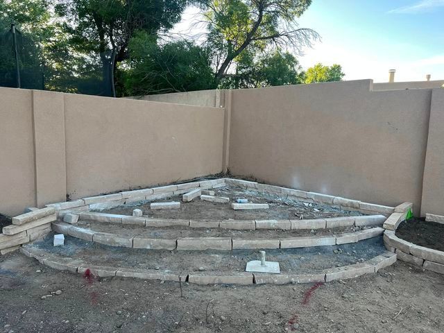 A brick staircase is being built in a backyard.