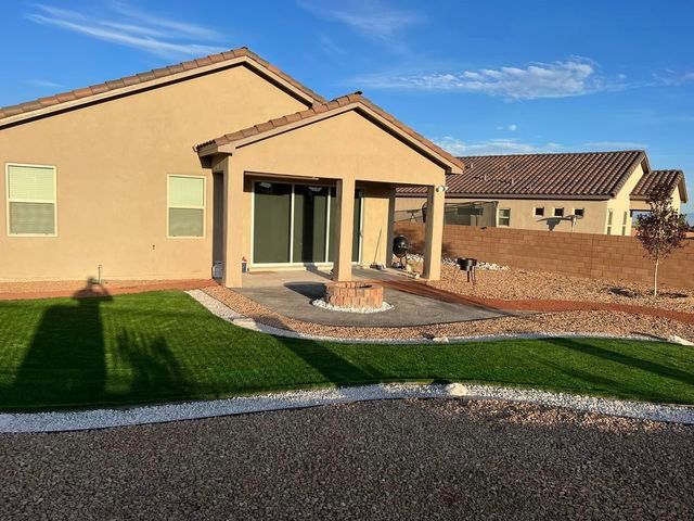 A house with a shadow on the grass in front of it