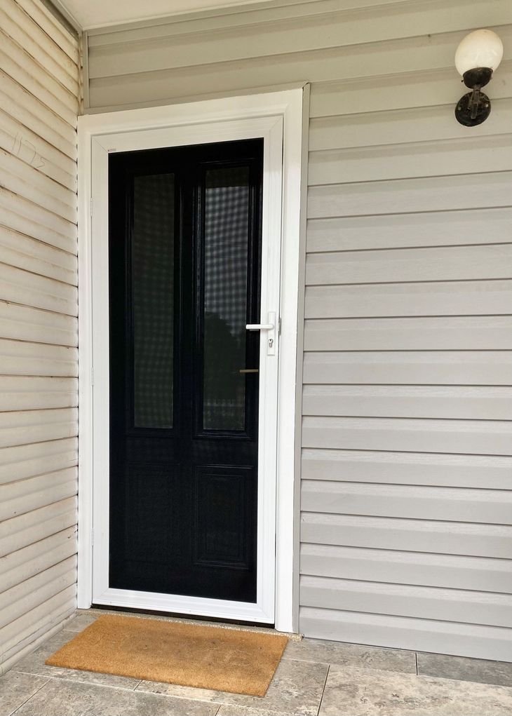 Aku Gard security door in a white frame