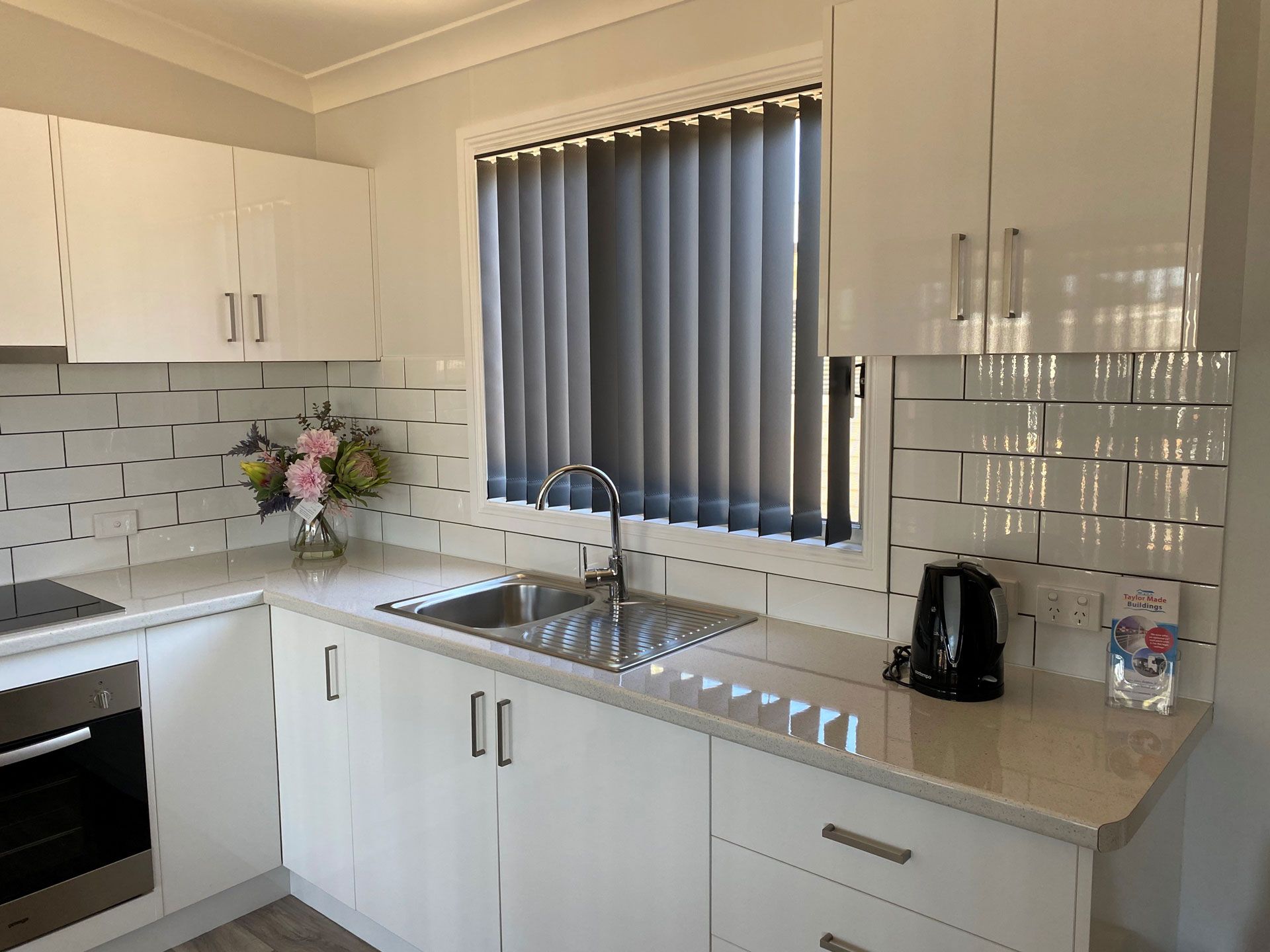 Charcoal vertical drapes in a kitchen window