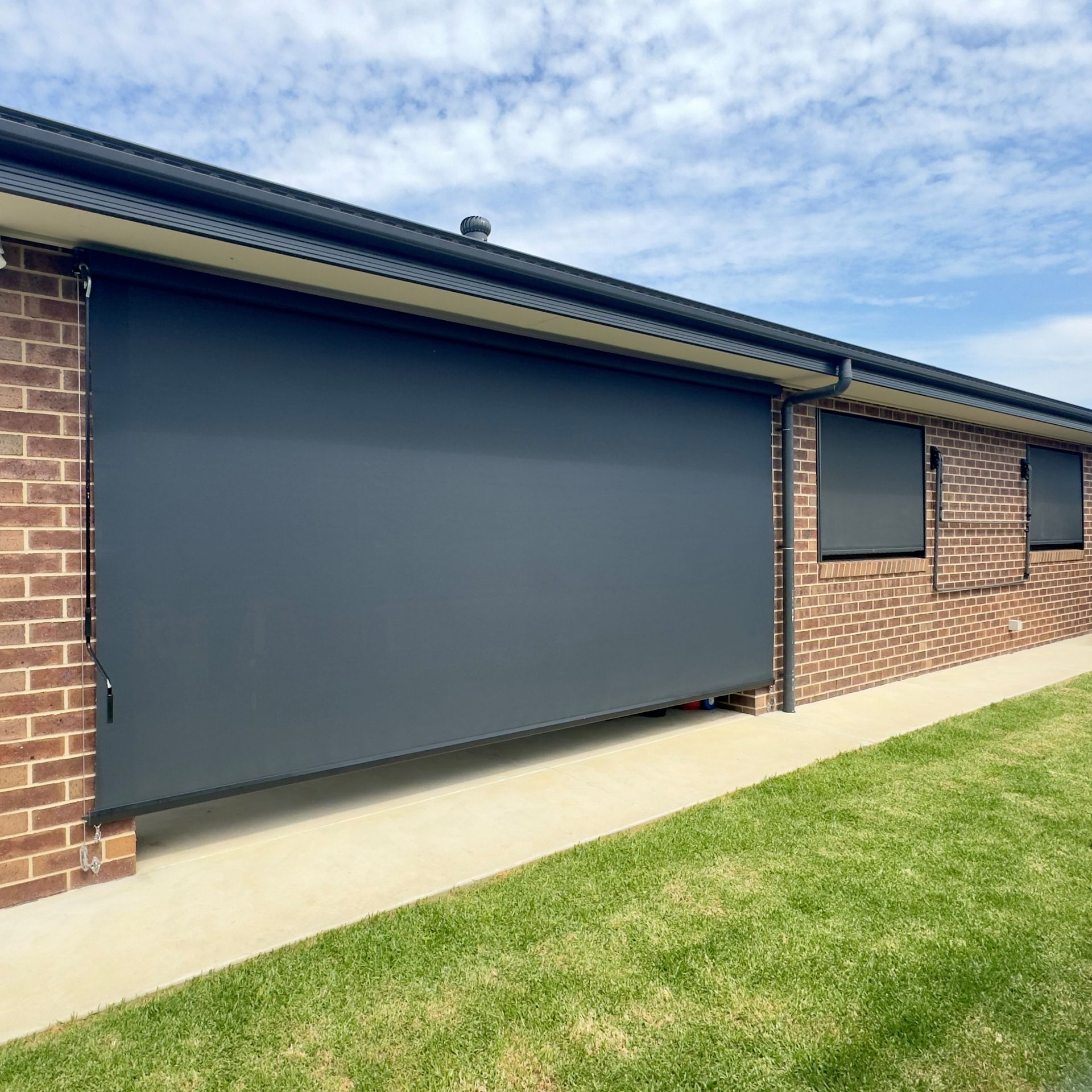 sunsscreen wire guide awning and side channel awnings on the exterior of a home