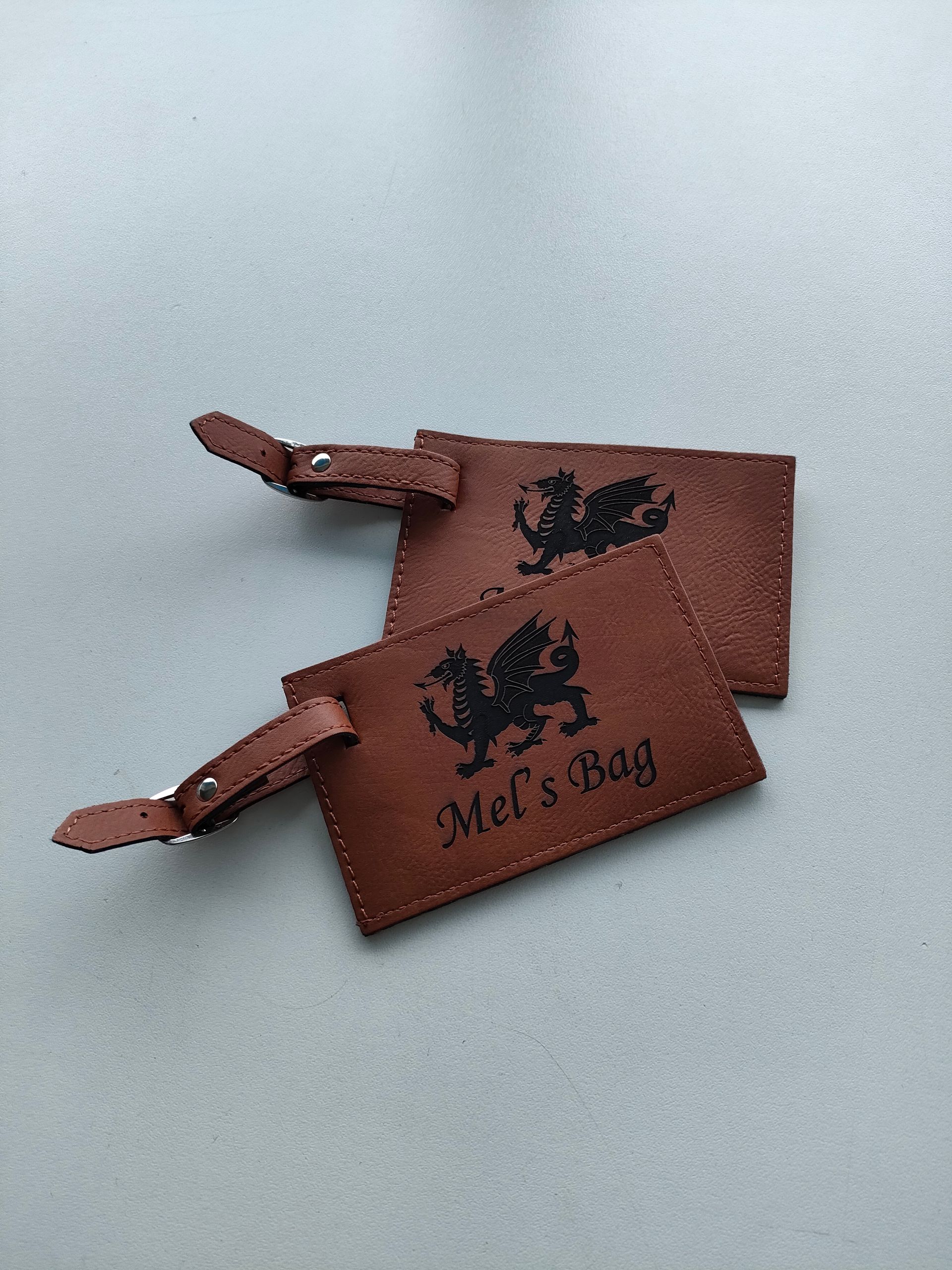 Two Brown Leather Bag Tags With Personalised Names Engraved — NMTG Engraving in Wollongong, NSW