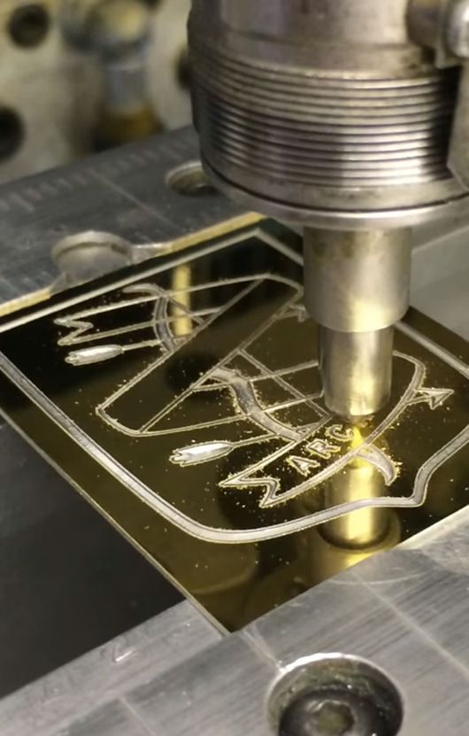 A Machine is Cutting a Piece of Metal on a Table — NMTG Engraving in Wollongong, NSW