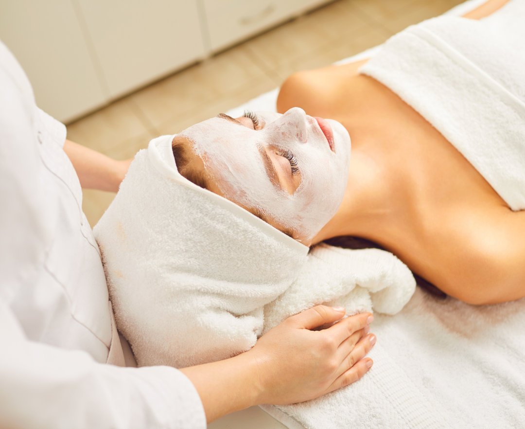 A woman is getting a facial treatment at a spa.