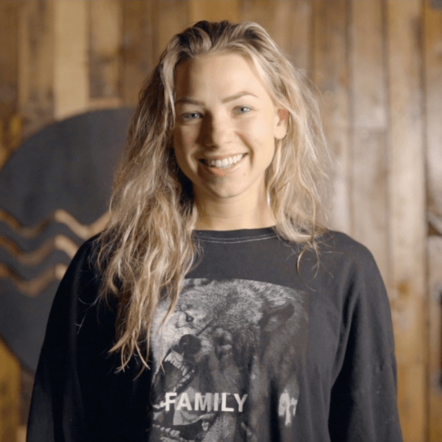 A woman wearing a black shirt with the word family on it