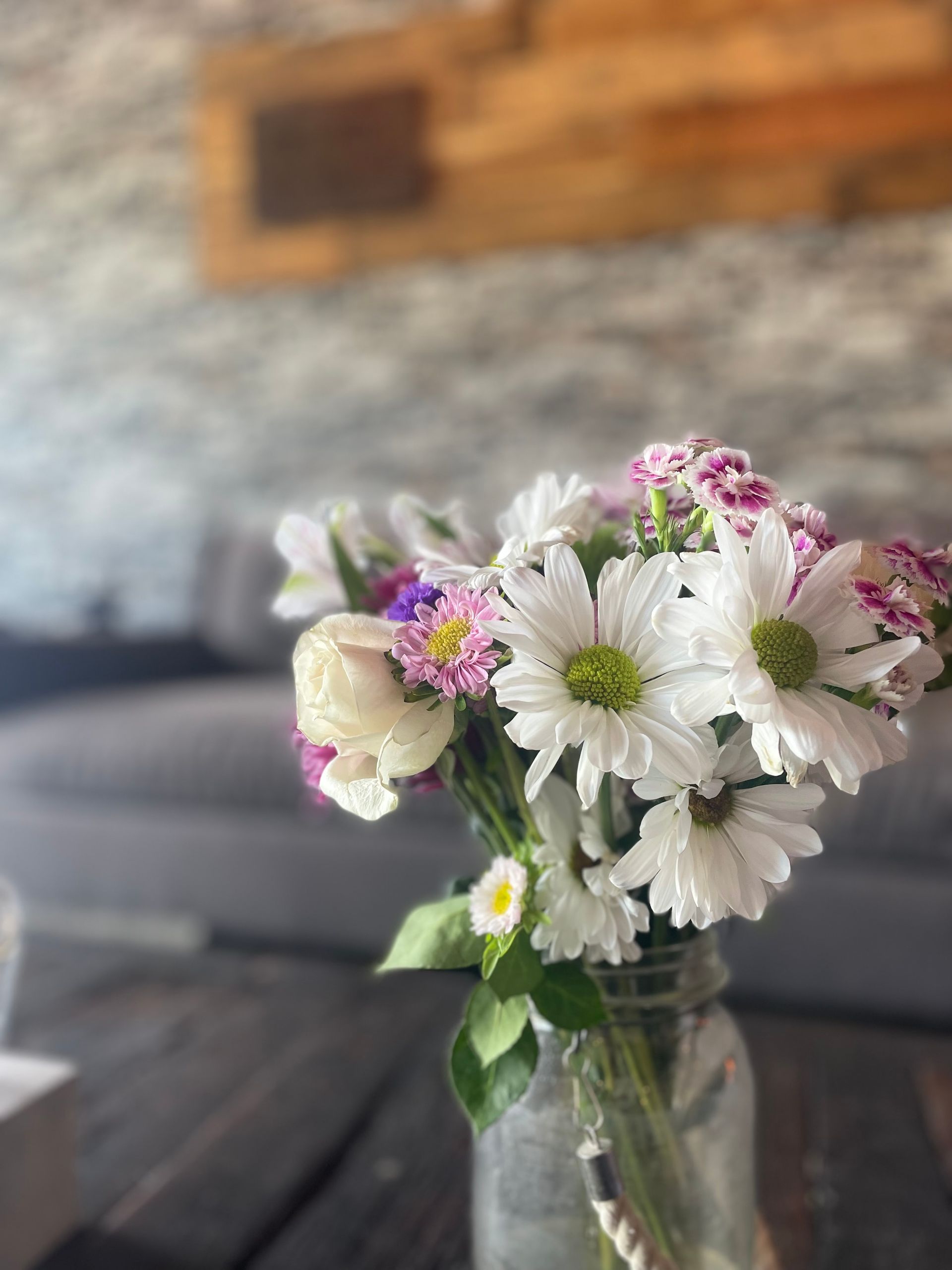 A vase filled with flowers is sitting on a table.