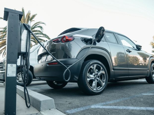 An electric car is being charged at a charging station.