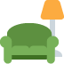 Green armchair with an orange lamp next to it.