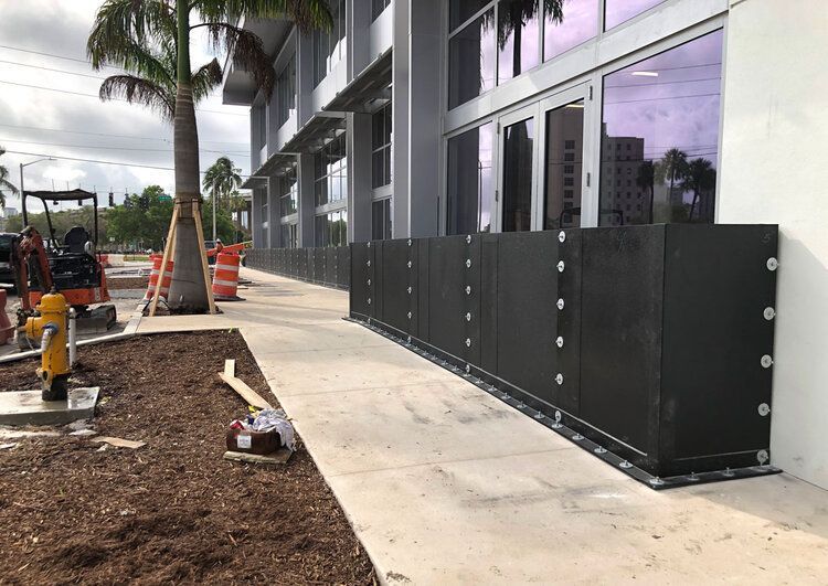 A building under construction with a fire hydrant in front of it.