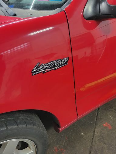 A red truck with the word lightning on the side