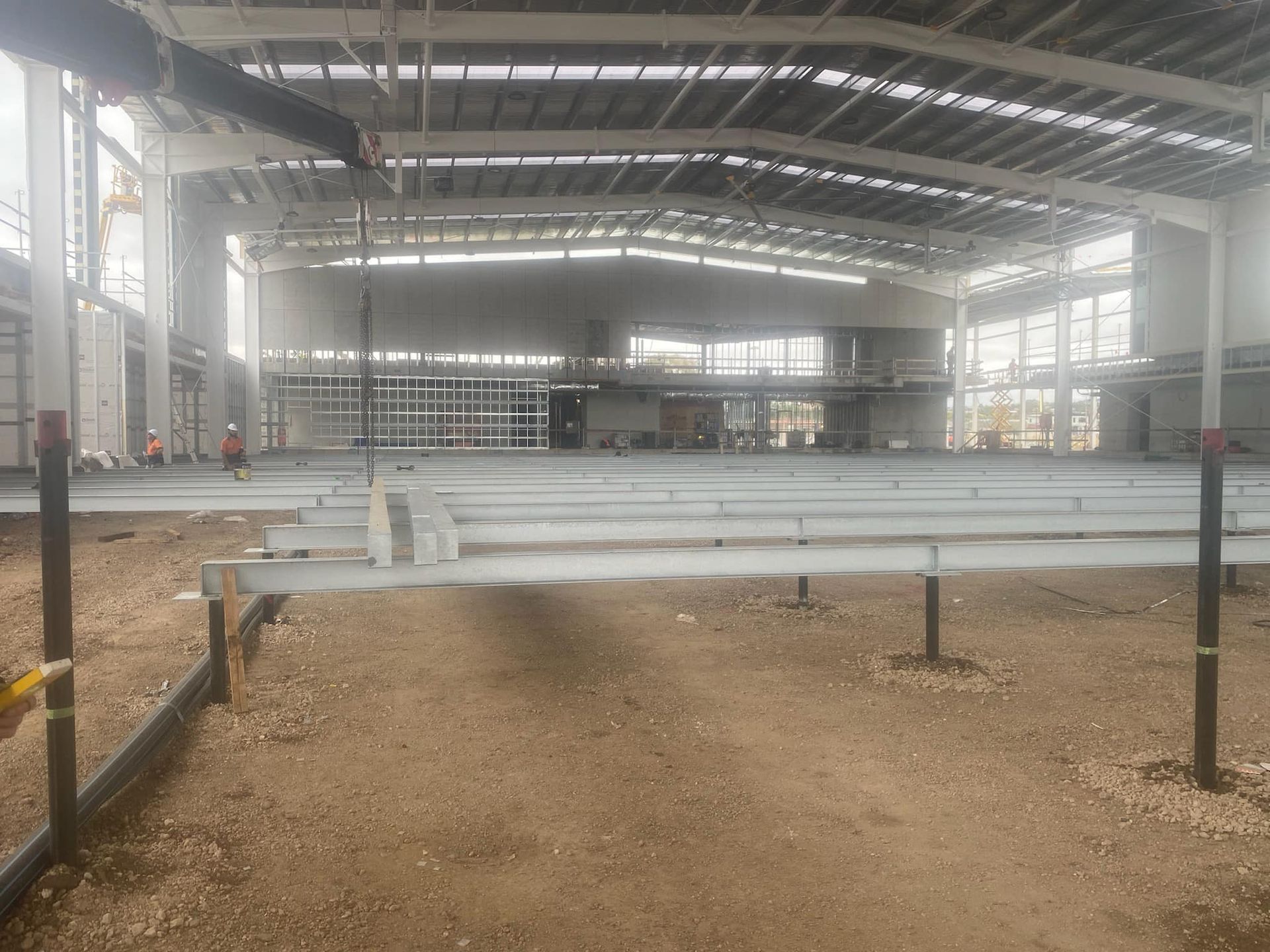 A large building under construction with a lot of pipes going through it.