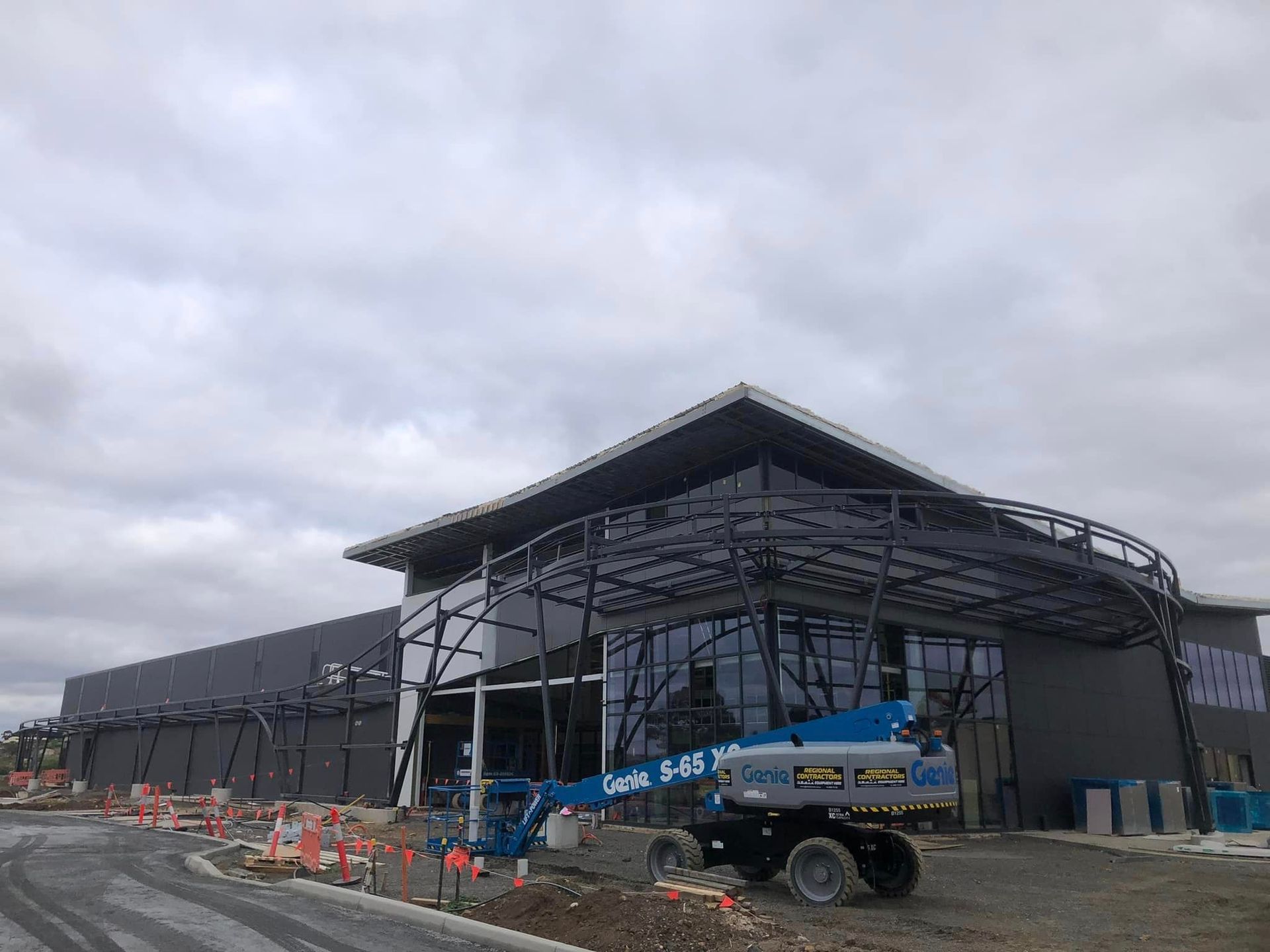 A large building under construction with a crane in front of it.