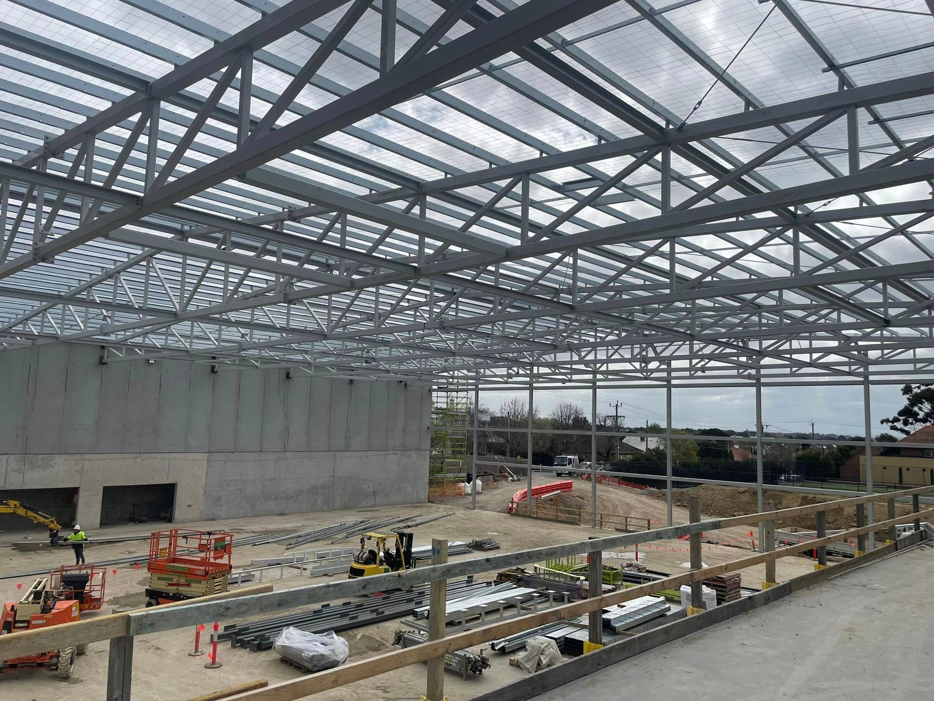 A large metal structure is being built on a construction site.