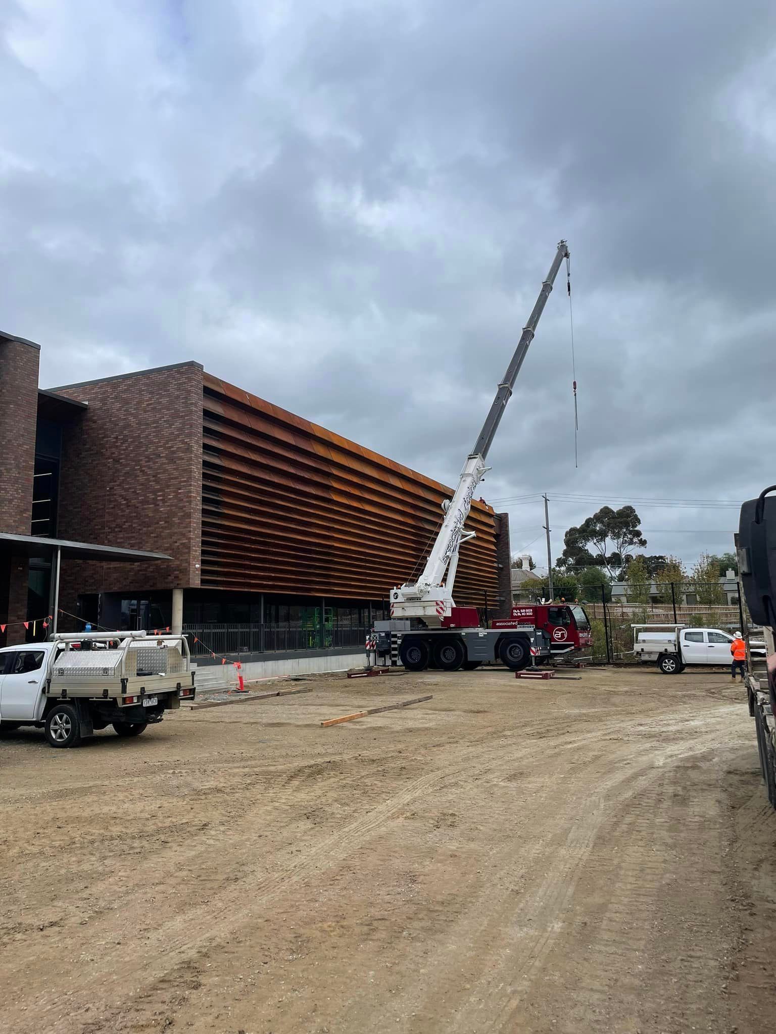A large building is being built with a crane in the background.